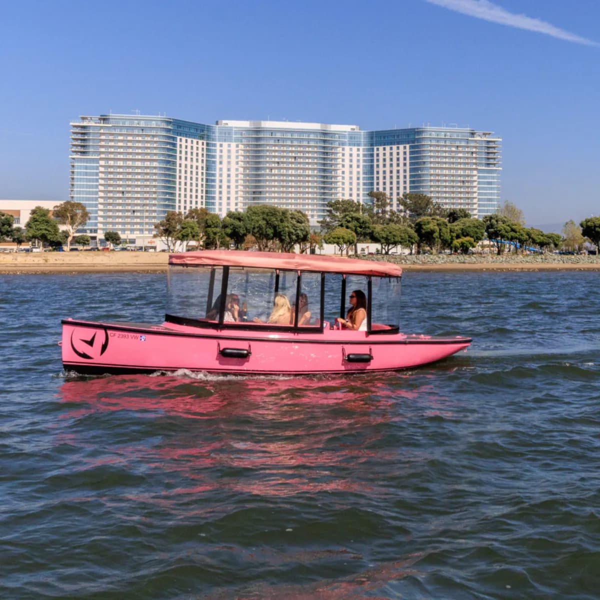 Pink electric boat rental for 9 on Harbor Island, San Diego